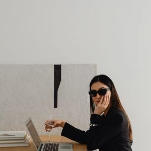 kaboompics_dark-classy-aesthetic-fashion-beautiful-asian-female-entrepreneur-in-black-suit-technology-and-devices-iphone-laptop-airpods-30044